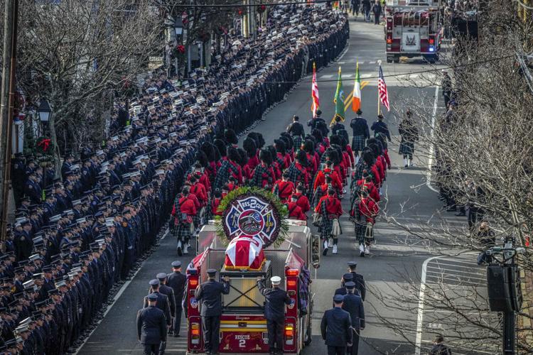 Hundreds fill church, line streets for firefighter's funeral